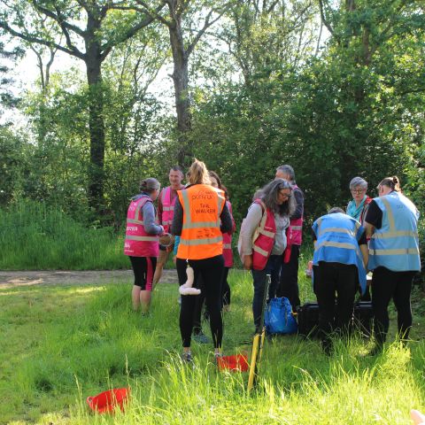 Volunteers at the park run recreational event on Saturdays. The group are wearing health and safety hi-vis jackets